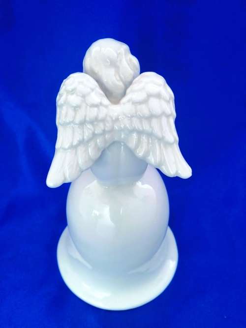 Continental blanc de chine Bell with Cherub sat on top