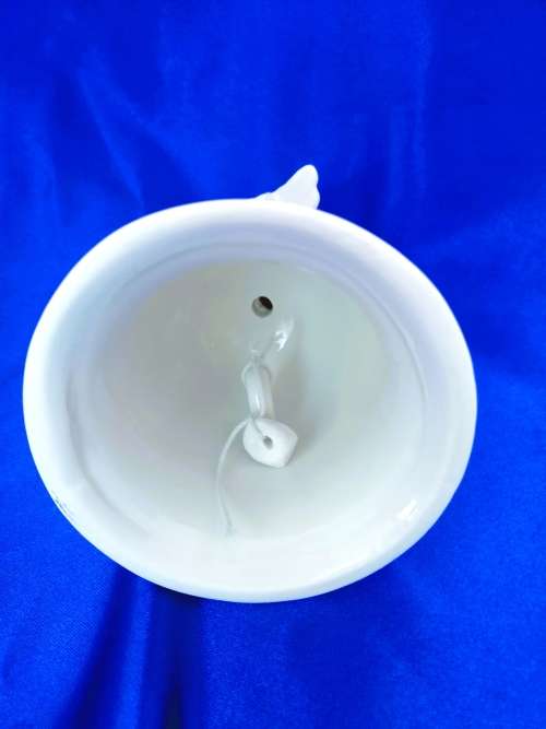 Continental blanc de chine Bell with Cherub sat on top