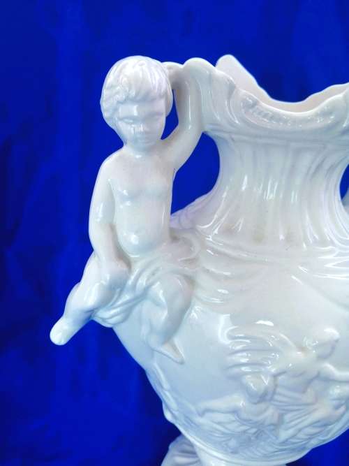Faiarte blanc de china two-handled vase depicting cherubs angels