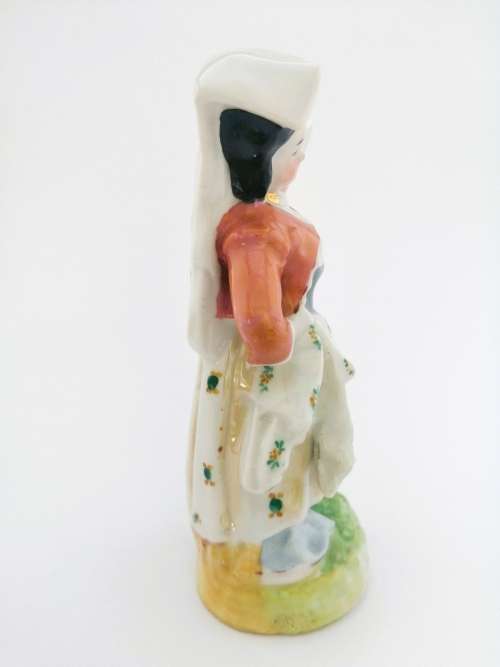 Continental figurine of a country maiden