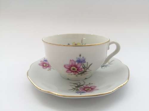 Pretty Demitasse cup and saucer White with flower design and gold trim