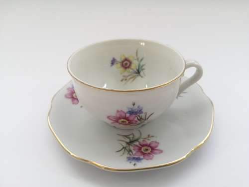 Pretty Demitasse cup and saucer White with flower design and gold trim