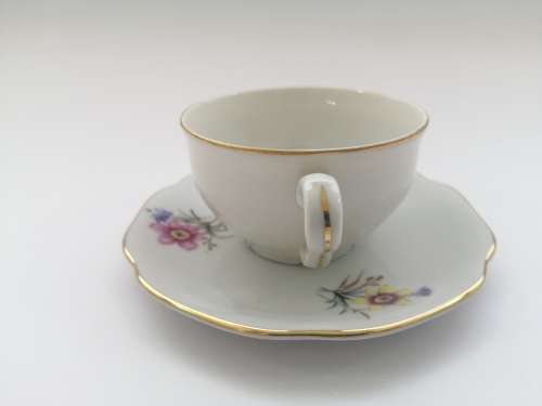 Pretty Demitasse cup and saucer White with flower design and gold trim