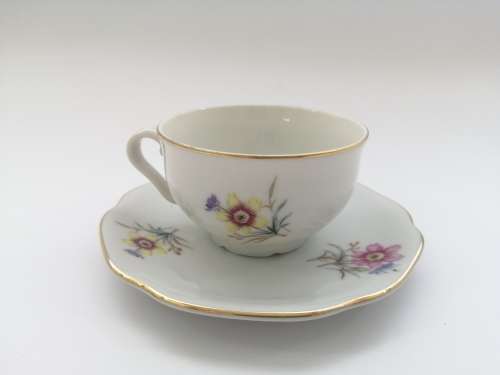 Pretty Demitasse cup and saucer White with flower design and gold trim