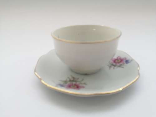 Pretty Demitasse cup and saucer White with flower design and gold trim