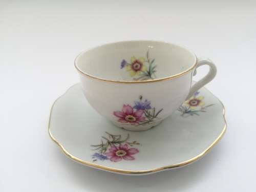 Pretty Demitasse cup and saucer White with flower design and gold trim