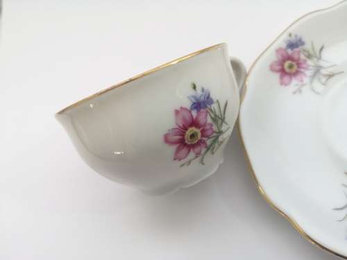 Pretty Demitasse cup and saucer White with flower design and gold trim