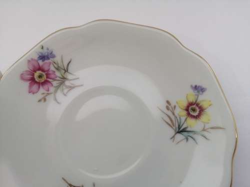 Pretty Demitasse cup and saucer White with flower design and gold trim