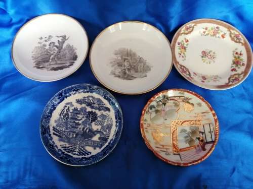 Five mixed china saucers plates and bowls