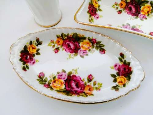 Fine Bone China Cottage Rose set of 4 items with gold trim.