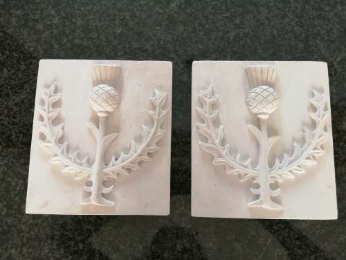 Pair of plaster-of-paris Thistle plaques