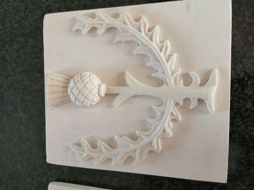 Pair of plaster-of-paris Thistle plaques