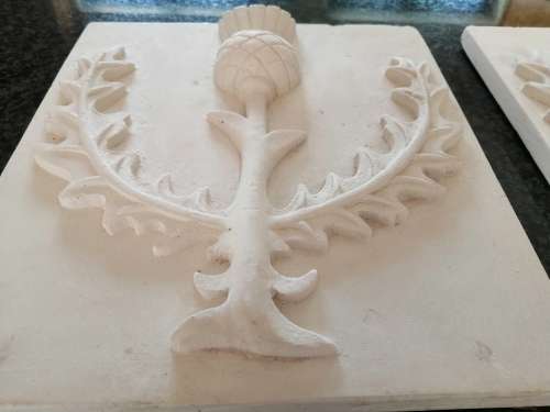 Pair of plaster-of-paris Thistle plaques