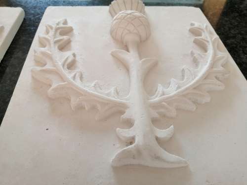 Pair of plaster-of-paris Thistle plaques