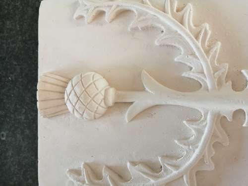 Pair of plaster-of-paris Thistle plaques
