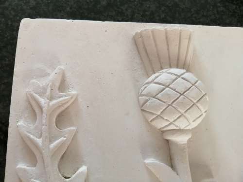 Pair of plaster-of-paris Thistle plaques