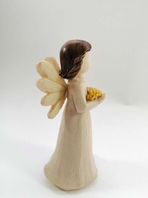 Willow Tree style wooden angel holding yellow flowers