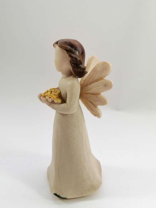 Willow Tree style wooden angel holding yellow flowers