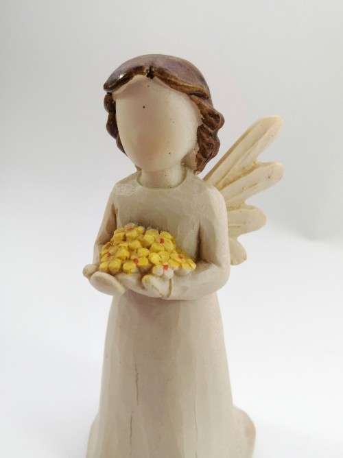 Willow Tree style wooden angel holding yellow flowers