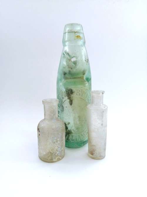 Three antique glass bottles