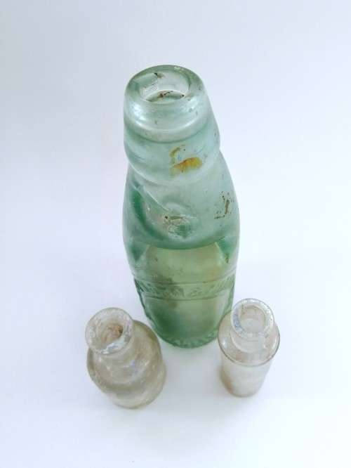 Three antique glass bottles