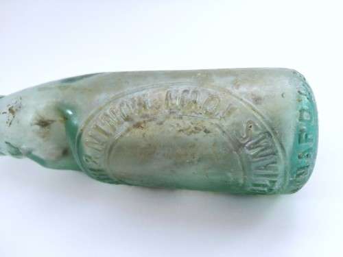 Three antique glass bottles