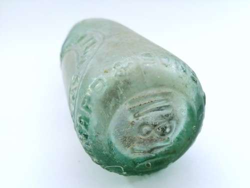 Three antique glass bottles