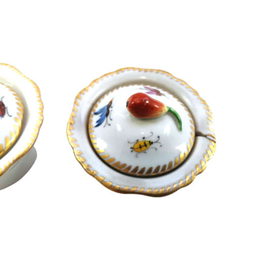 Antique lidded pots showcase charming motifs, including ladybird and butterflies