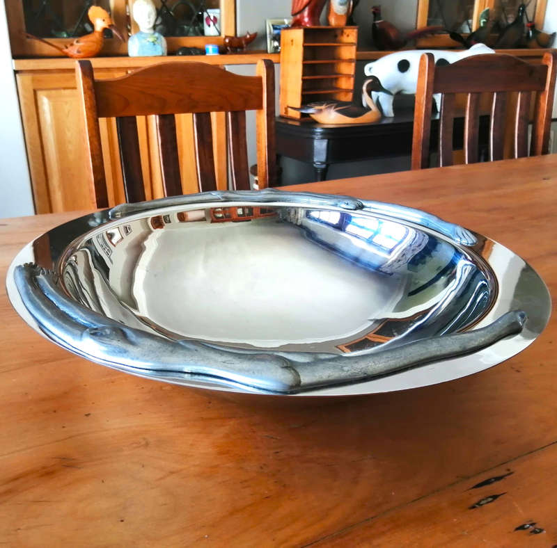 Carrol Boyes Eye-catching Stainless Steel Fruit Bowl has Sculptural figure-like fixtures on the rim