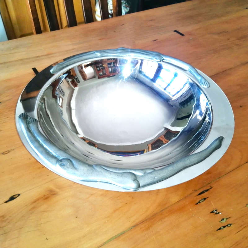 Carrol Boyes Eye-catching Stainless Steel Fruit Bowl has Sculptural figure-like fixtures on the rim