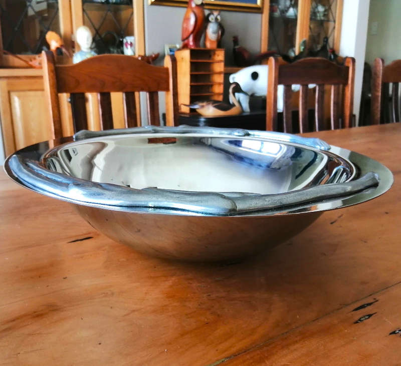 Carrol Boyes Eye-catching Stainless Steel Fruit Bowl has Sculptural figure-like fixtures on the rim