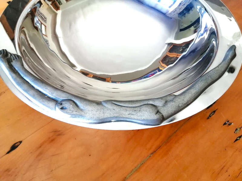 Carrol Boyes Eye-catching Stainless Steel Fruit Bowl has Sculptural figure-like fixtures on the rim