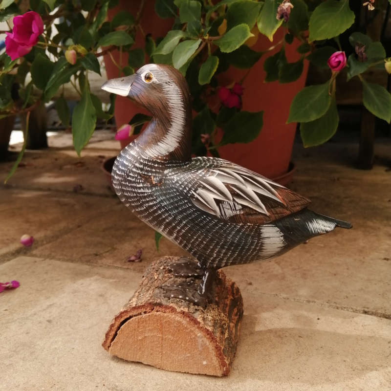 Wooden Hand carved Duck standing on a Log