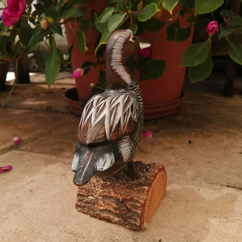 Wooden Hand carved Duck standing on a Log