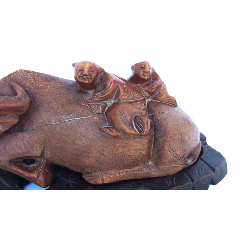 Antique Chinese wood carving depicting an Ox or Water Buffalo with two passengers