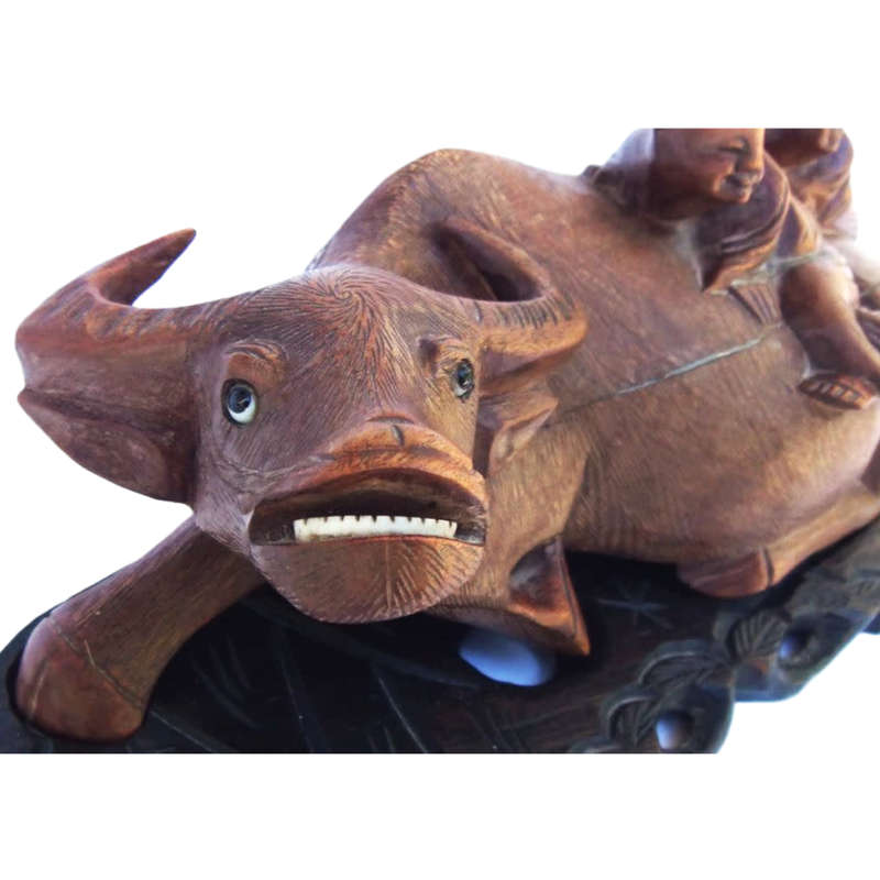 Antique Chinese wood carving depicting an Ox or Water Buffalo with two passengers