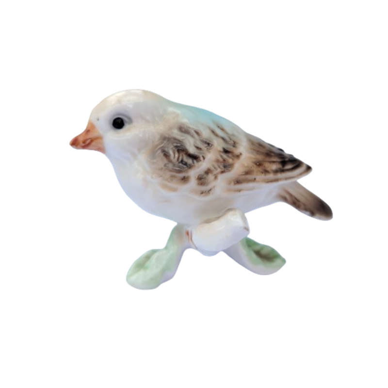 Vintage bird figure mounted on a tree trunk base.