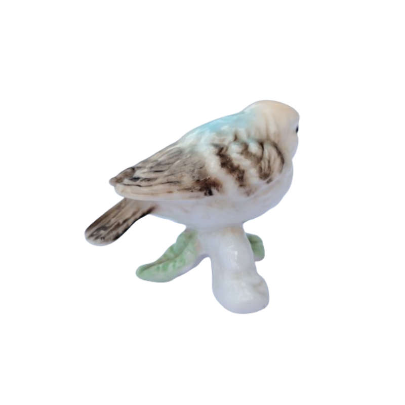 Vintage bird figure mounted on a tree trunk base.