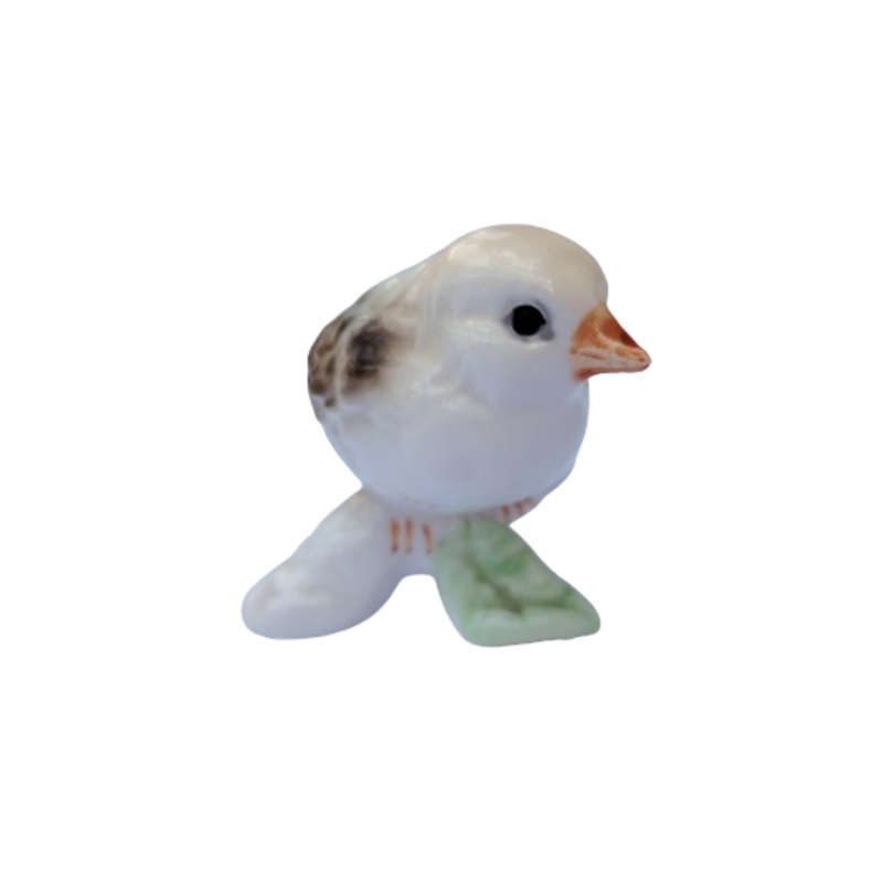 Vintage bird figure mounted on a tree trunk base.