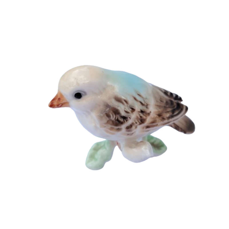 Vintage bird figure mounted on a tree trunk base.