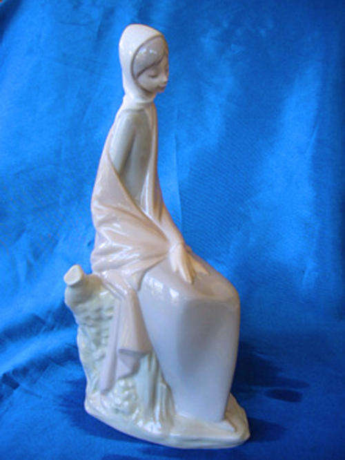 Lladro / NAO Figure - Lady Sat on Tree Trunk