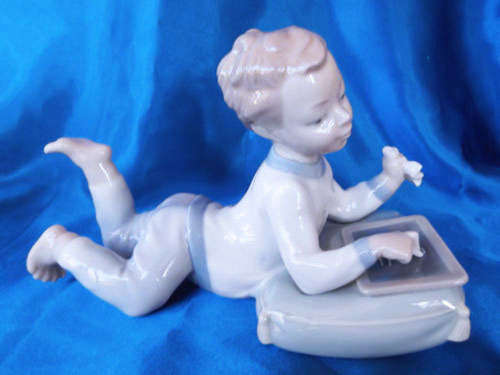 lladro Nao Boy Lying down with his slate board Chalkboard drawing a train