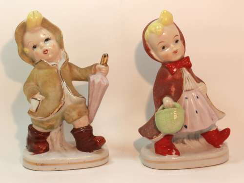 Charming Little Boy and Girl in Hooded Jackets Porcelain Figurines.