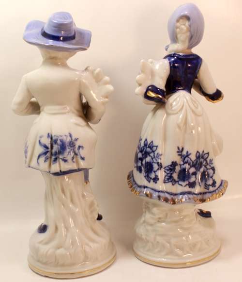 Man and Woman Matching Pair of Porcelain Ornamental Figurines in Victorian Finery.