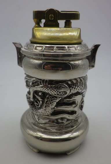 Unusual vintage dragon musical table lighter. Plays AULD LANG SYNGE. Chrome plated