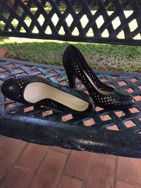 High black heels featuring small square cut outs