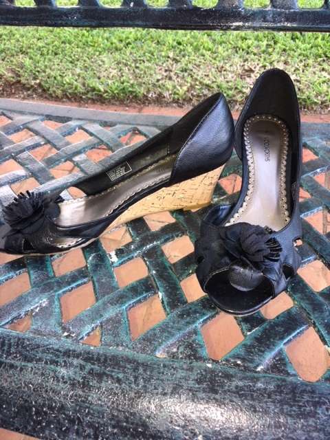 Black low cork wedge heels with open toe and pom pom flowers