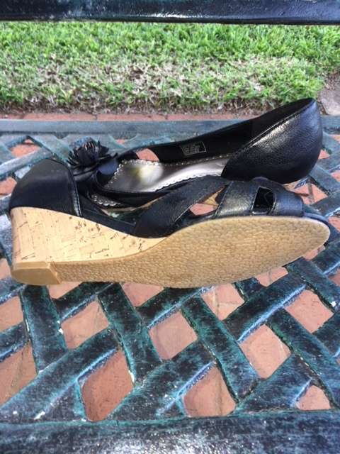 Black low cork wedge heels with open toe and pom pom flowers