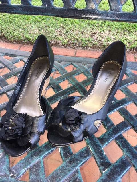 Black low cork wedge heels with open toe and pom pom flowers