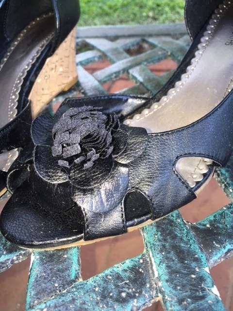 Black low cork wedge heels with open toe and pom pom flowers